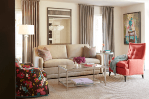 jessica charles living room peach and beige sofa and armchair with white lamp and curtains