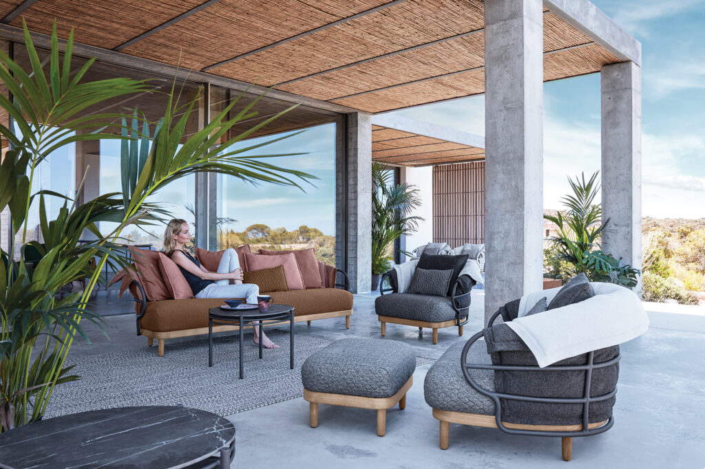 Woman lounging on outdoor seating on patio