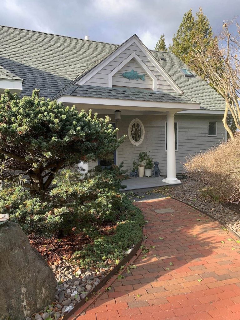 Grey house at the end of brick path